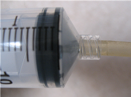 aquarium tubing pressed on to end of syringe
