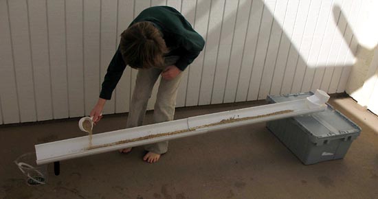 Environmental Engineering  Science Project child sprinkling sand evenly over the extender