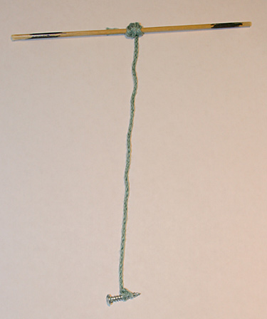 Chemistry Science Project string tied to a skewer and weighed down with a screw at the other end