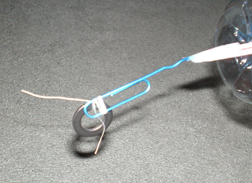 Figure 7. When the rotor spins, it turns the paper clip and winds up 