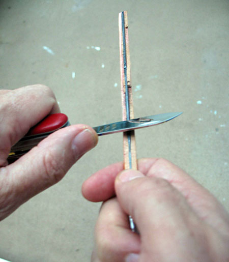 Electricity and Electronics  Science Project This photo shows a number two pencil being held in one hand while a pocket knife scrapes off the wood with the other to expose the graphite core below.
