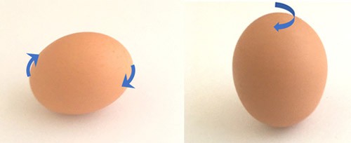 An egg spinning on its tip and an egg laying flat and spinning.