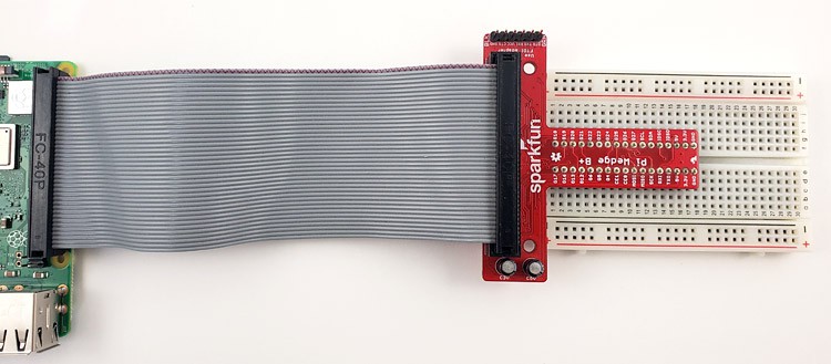 The Pi Wedge plugged into a breadboard and connected to the Raspberry Pi with a ribbon cable.