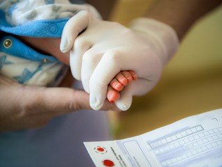 Newborn foot getting blood work done