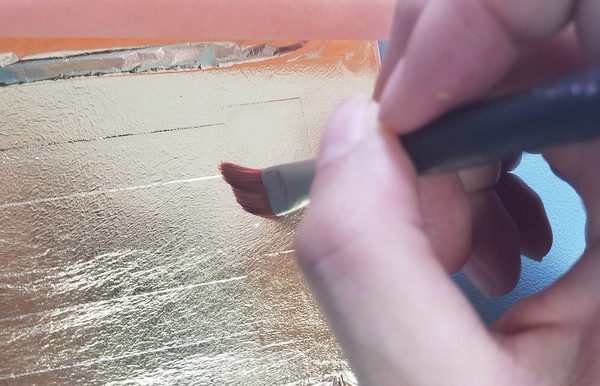Reinforcing corners and edges with smaller paintbrush 