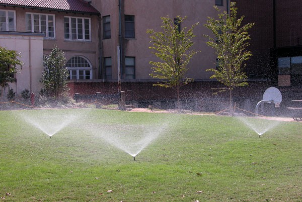 Photo of sprinklers watering a lawn