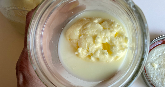 Shaken butter in a jar with separated buttermilk