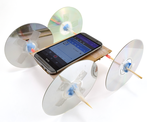 Car made from craft materials and compact discs for wheels