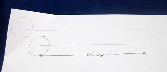 A circle with a line drawn outward from its center is drawn twice on a piece of paper
