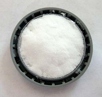 Baking soda packed into the inside of a film canister lid