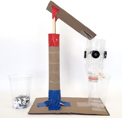 A recycling sorting machine made from cardboard, a plastic bottle, and magnets 