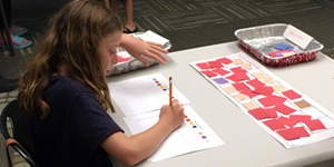 Summer Science at the Library / student doing the denial of service activity as part of a STEM workshop at her local library