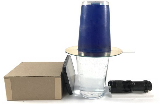 A box, two cups, a CD, a flashlight and a smartphone
