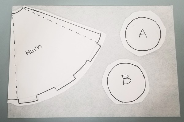 Paper template pieces taped onto felt 