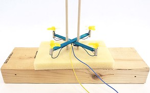 drone mounted on two vertical dowels through the straws