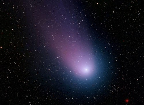 Composite image of comet traveling across a black sky