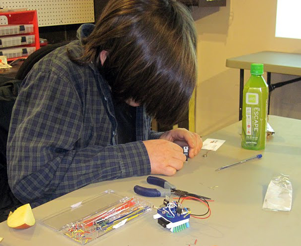 A student assembling a bristle bot