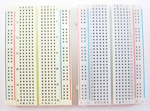 Two half sized breadboards with reversed bus designs