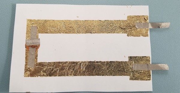Conductive fabric leads extending off of metal leaf circuit. 