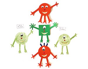 Four alien creatures created from construction paper and drawn on a paper. 