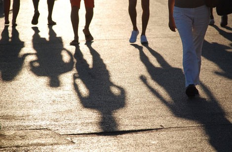 Shadows of people on the street.