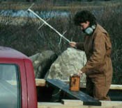 A scientist holds a large antenna and receiver