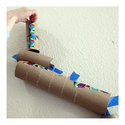 Wall marble run with kid putting marble through the top - Awesome Summer Science Experiments