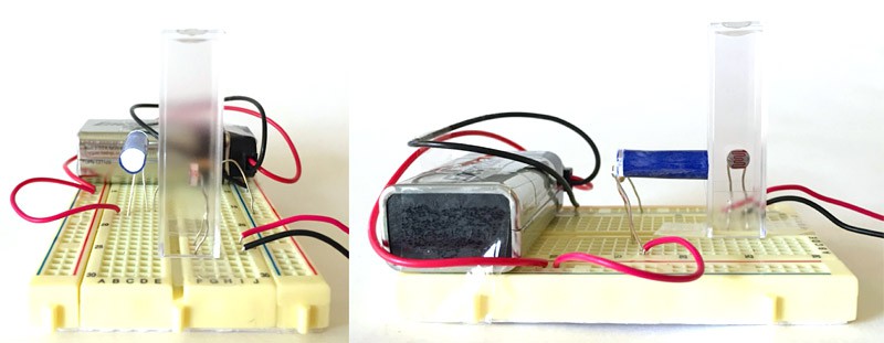 An LED and a photoresistor are aligned perpendicularly on a breadboard at the same height