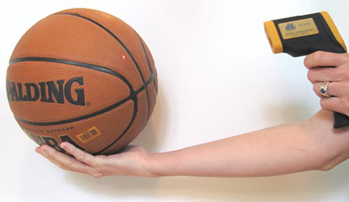 The temperature of a basketball is measured using an infrared thermometer