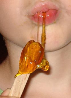 A person eating a maple taffy