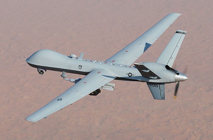 A reaper drone flying in the air.
