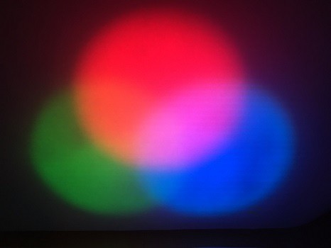 Three lights overlapping on the wall: red, green, and blue