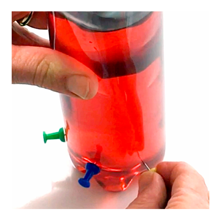Poking holes in plastic bottle with pushpins - Awesome Summer Science Experiments