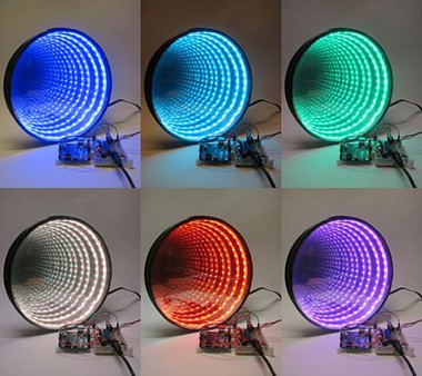 Rings of light in six different colors seem to repeat forever in a circular infinity mirror 