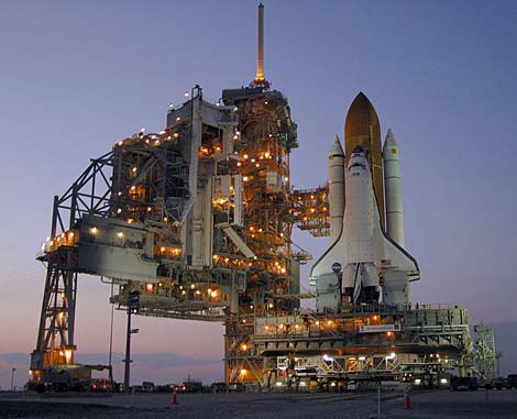 Photo of a NASA space shuttle on a launch pad