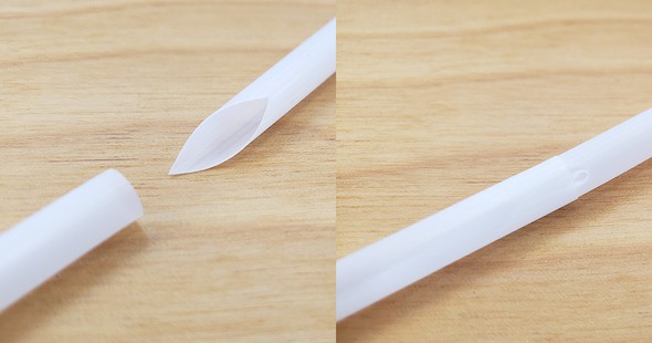 The pointed end of one straw inserted into the end of another straw.