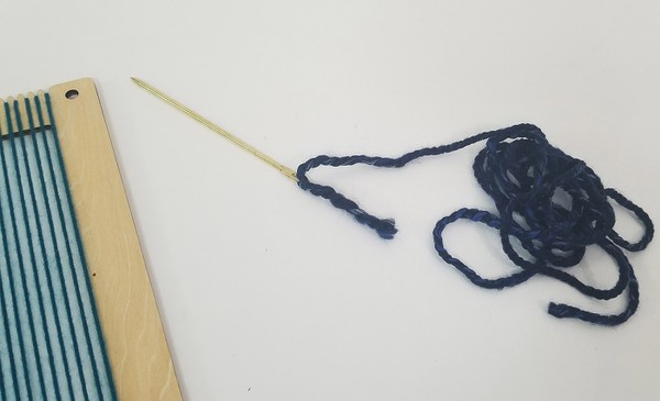 Threaded tapestry needle. 