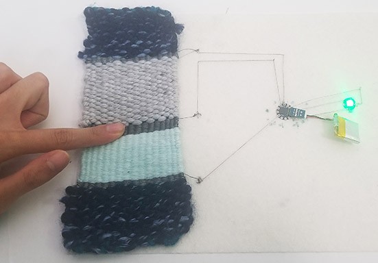 Woven sensor patch connected to LED 