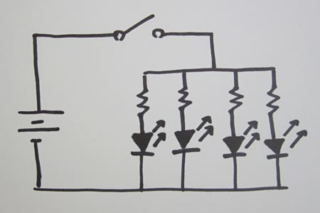 Drawing of a circuit with a battery, switch and four LEDs in parallel