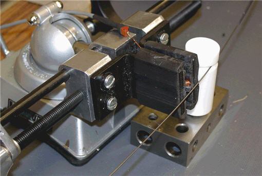 The read and write head touches the wire next to the teflon cylinder