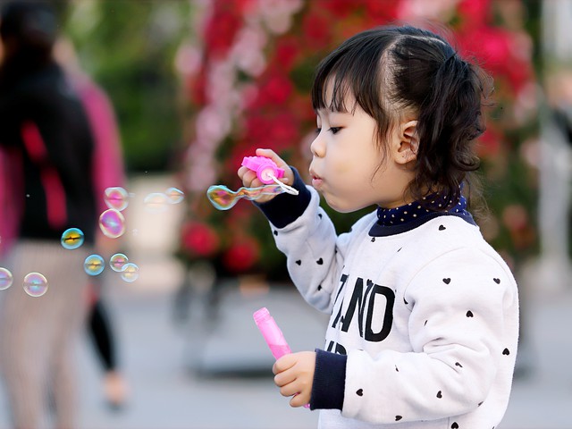 Child blowing bubbles