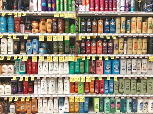 Six fully stocked shelves of different shampoo products