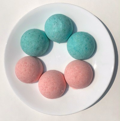 Three blue and three pink domes sit on a plate