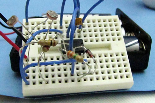 A fully wired breadboard that uses photoresistors to active a servo motor
