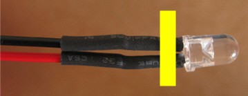 Heat shrink tubing protects wires that are soldered to the leads of an LED