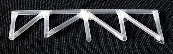 The diagonal supports of a Howe truss bridge are built with straws and tape