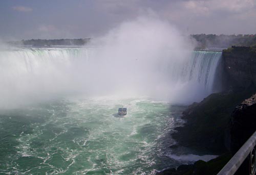 Photo of a large cloud of mist covering a waterfall