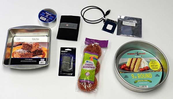 Aluminum tape, wire mesh and cake pan next to a steel pan, copper scrubbers, RFID shield, usb cable and RFID reader kit