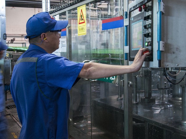 man cutting metal precisely with CNS machine