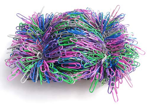 Hundreds of multi-colored paperclips are stuck to a large magnet